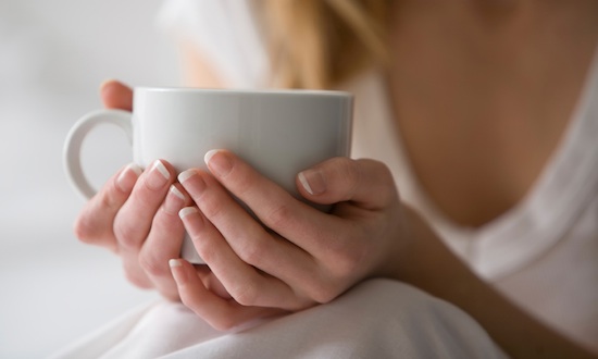 Hands holding a coffee mug